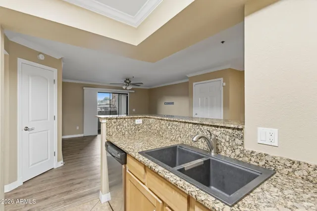 a kitchen with granite countertop a sink and a stove top oven