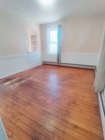 a view of white cabinets and wooden floor