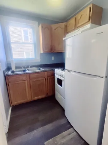 a bathroom with a sink toilet a mirror and shower