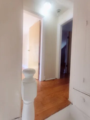 a view of a room with wooden floor and windows