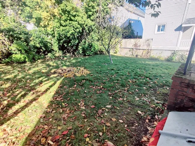a white house with a tree in the background