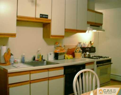 10 Windsor Road Edison, NJ 08817 - Photo 3 of 7 a kitchen with a sink a stove and cabinets
