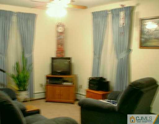10 Windsor Road Edison, NJ 08817 - Photo 5 of 7 a living room with furniture and a flat screen tv