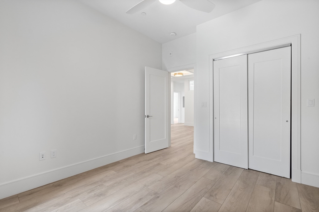 1580 Beacon Street, Unit 100 Brookline, MA 02446 - Photo 15 of 17 a view of an empty room and wooden floor