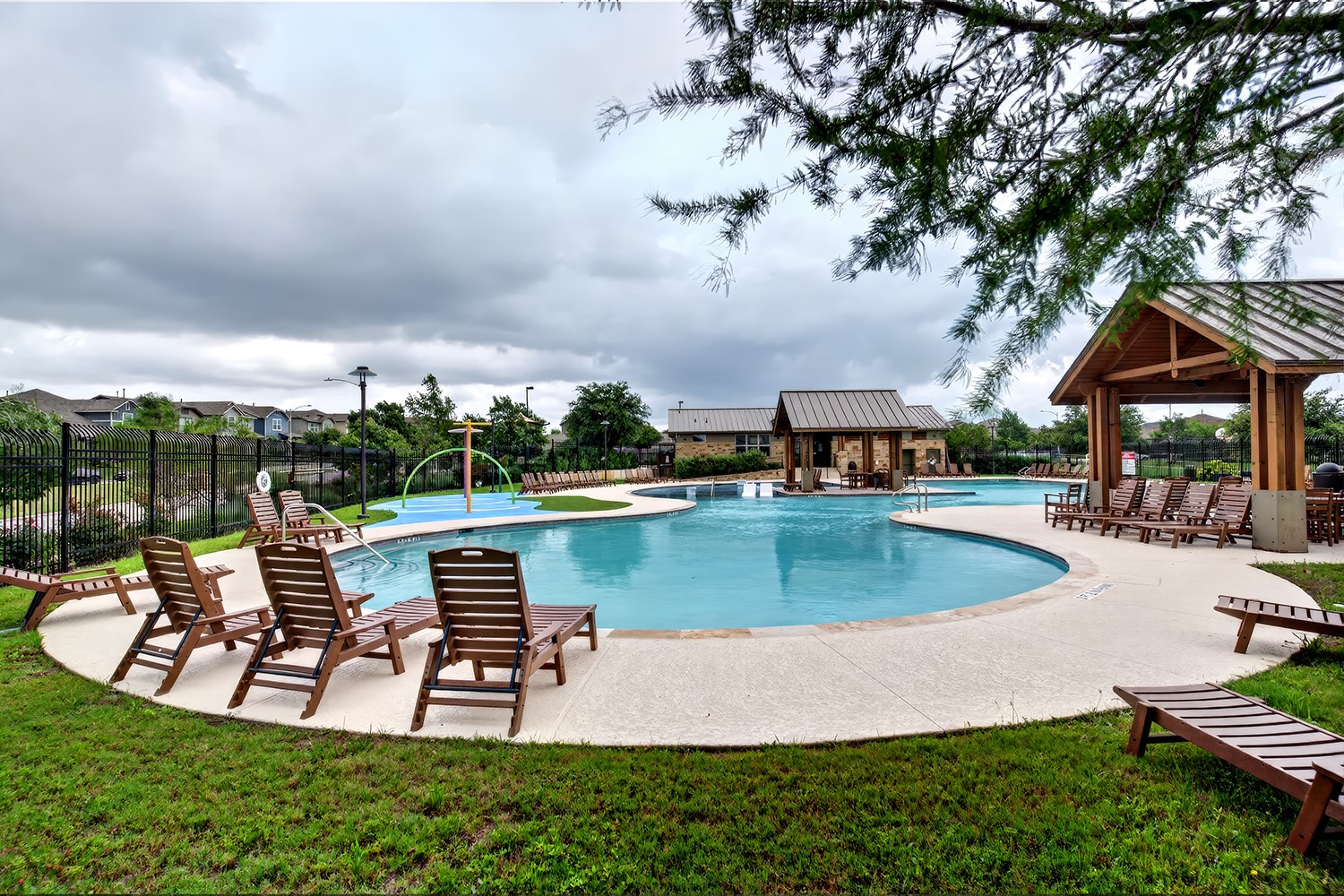 2006 Grow Lane Austin, TX 78754 - Photo 35 of 40 An inviting community pool with ample lounge seating and covered cabanas awaits leisurely afternoons.