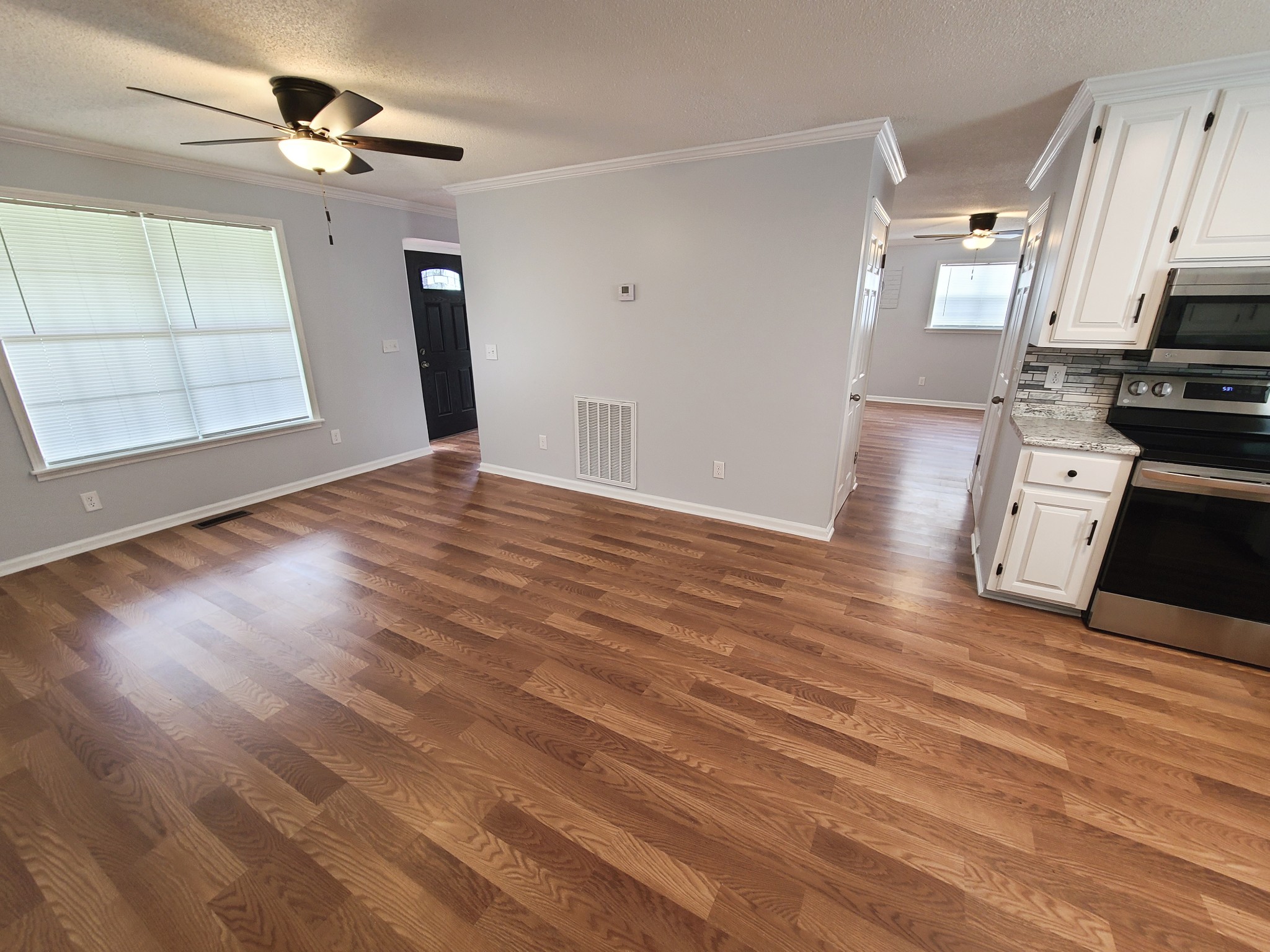 89 Bassham Road Five Points, TN 38457 - Photo 11 of 48 a view of a kitchen with wooden floor and a ceiling fan