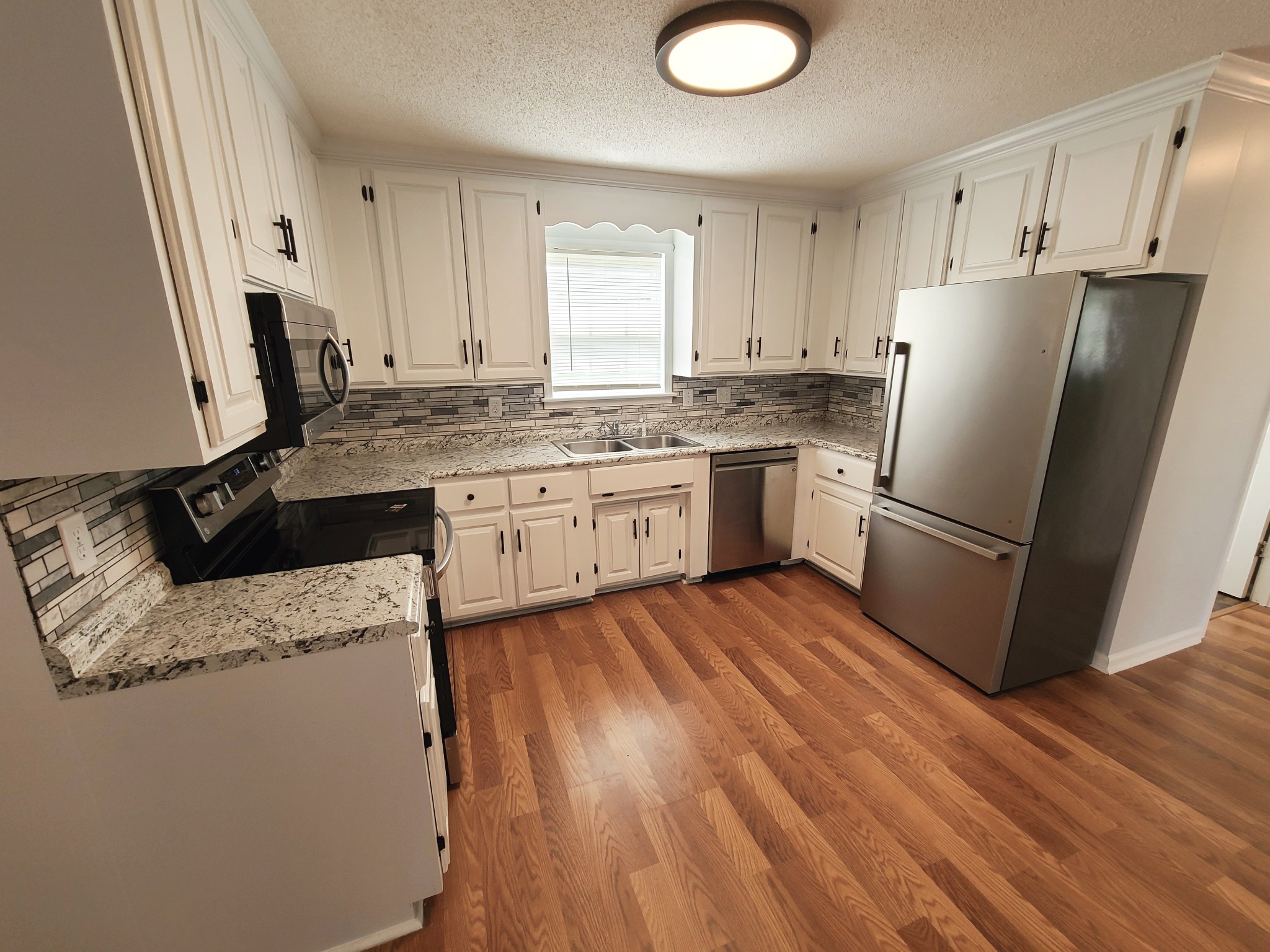 89 Bassham Road Five Points, TN 38457 - Photo 10 of 48 a kitchen with a refrigerator sink and stove