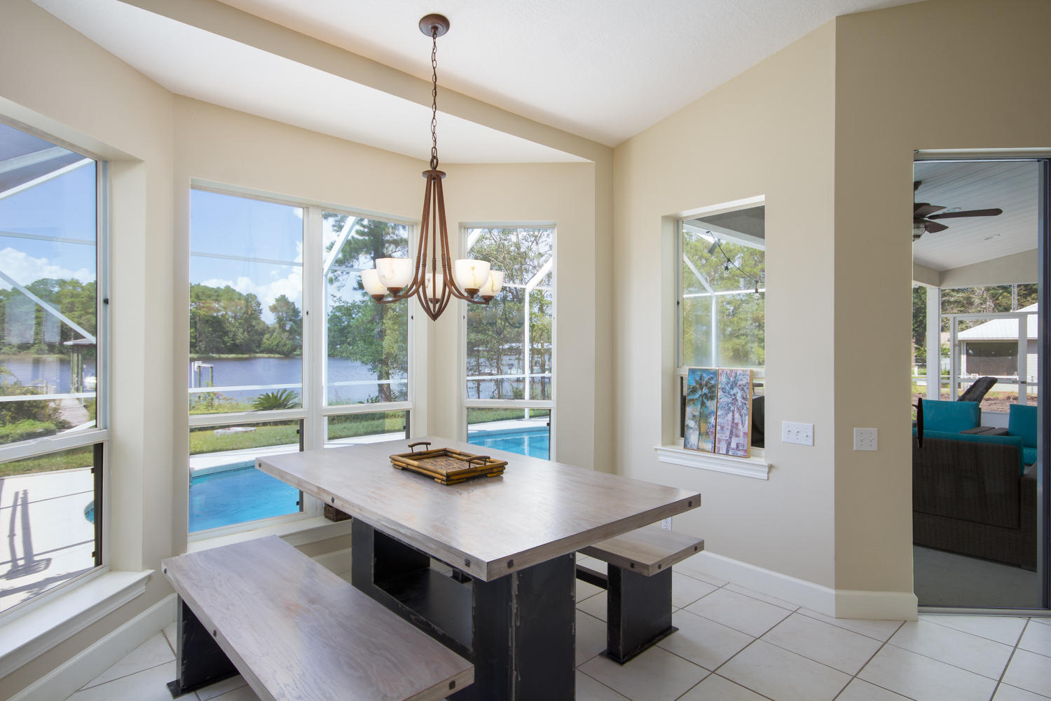 754 Bay Grove Road Freeport, FL 32439 - Photo 9 of 23 a view of a dining room and livingroom with furniture wooden floor a chandelier