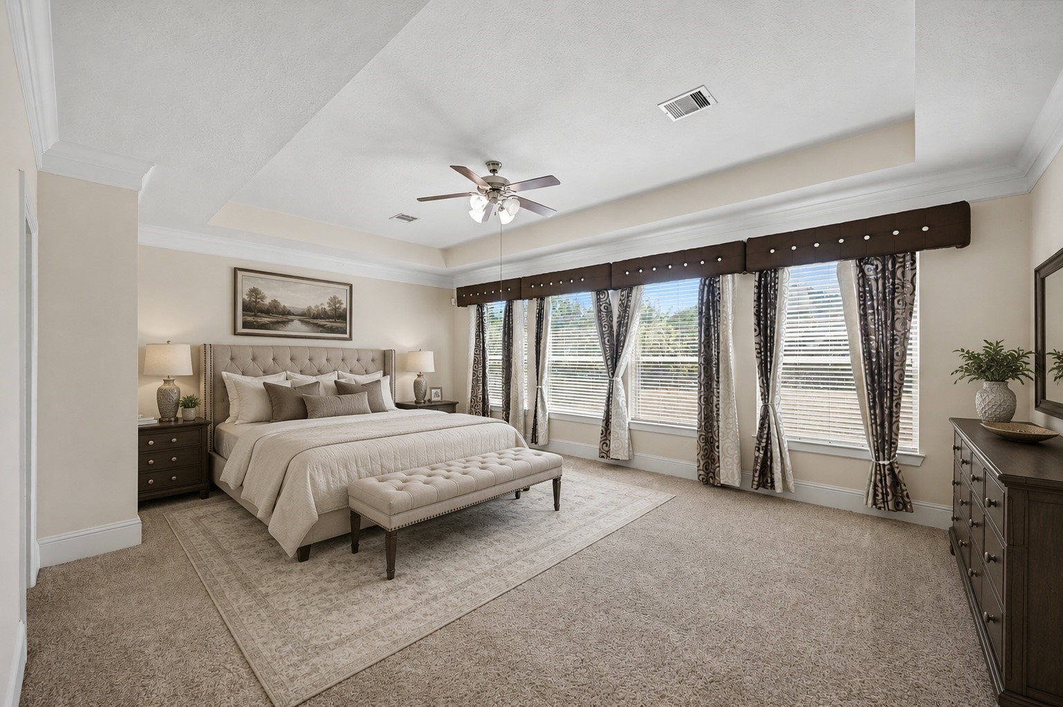 31325 Riley Woods Court Spring, TX 77386 - Photo 22 of 50 A spacious primary retreat with room for a king size bed and additional furnishings, complemented by a tray ceiling and a wall of windows overlooking the backyard. Virtually staged with AI generated furniture and decor.
