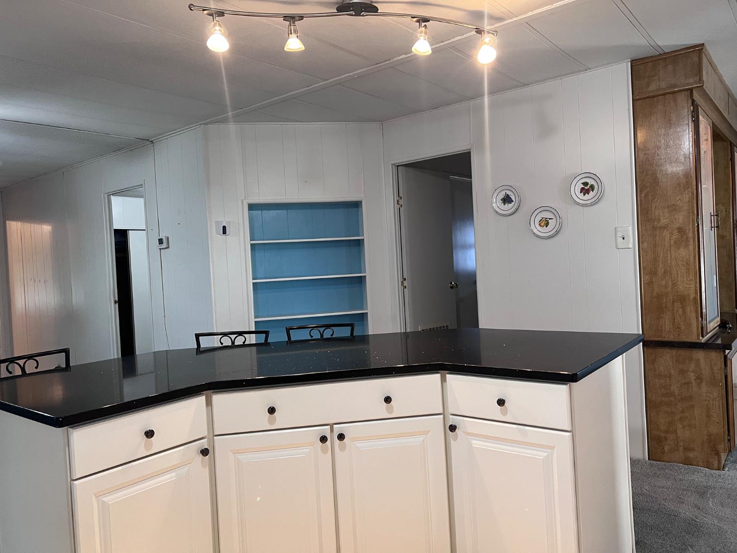 3913 Waimea Lane Modesto, CA 95355 - Photo 15 of 32 a kitchen with granite countertop a refrigerator and a sink