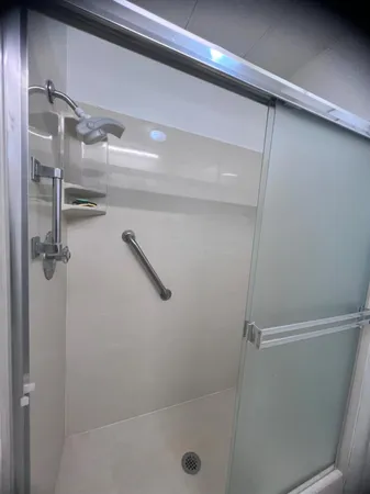 a bedroom with a bed and a lamp with wooden floor