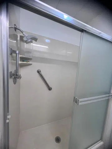 a bedroom with a bed and a lamp with wooden floor