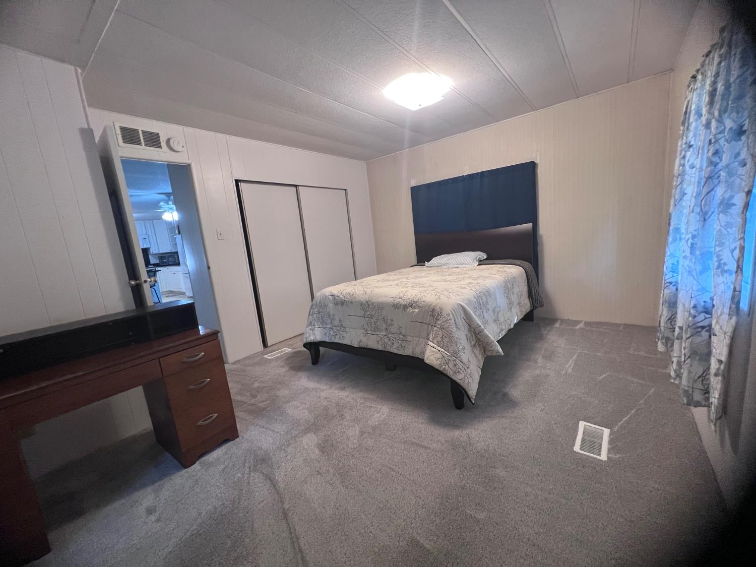 3913 Waimea Lane Modesto, CA 95355 - Photo 27 of 32 a spacious bedroom with a bed and a dresser