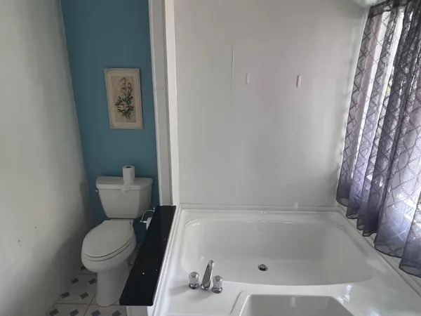 a bathroom with a bathtub and shower