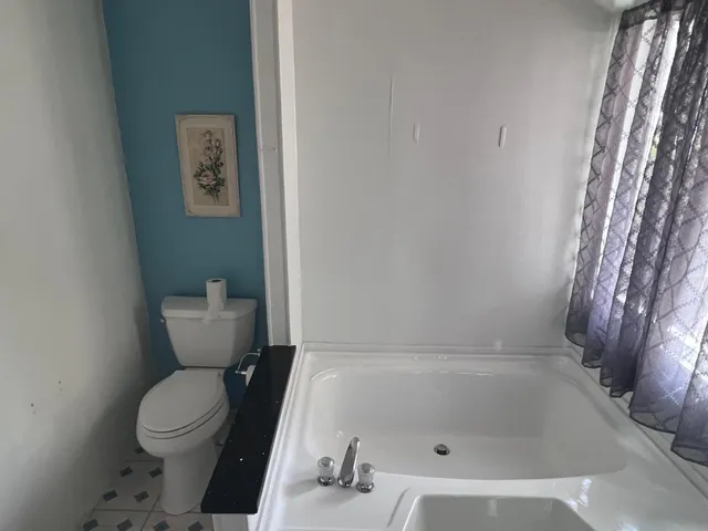 a bathroom with a bathtub and shower