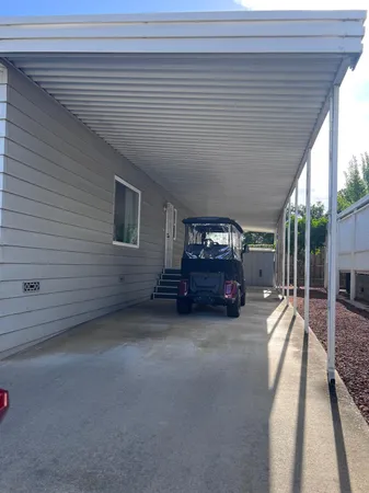a view of a livingroom with furniture and floor to ceiling window