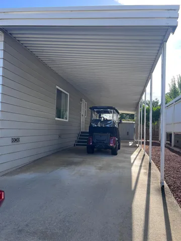 a view of a livingroom with furniture and floor to ceiling window