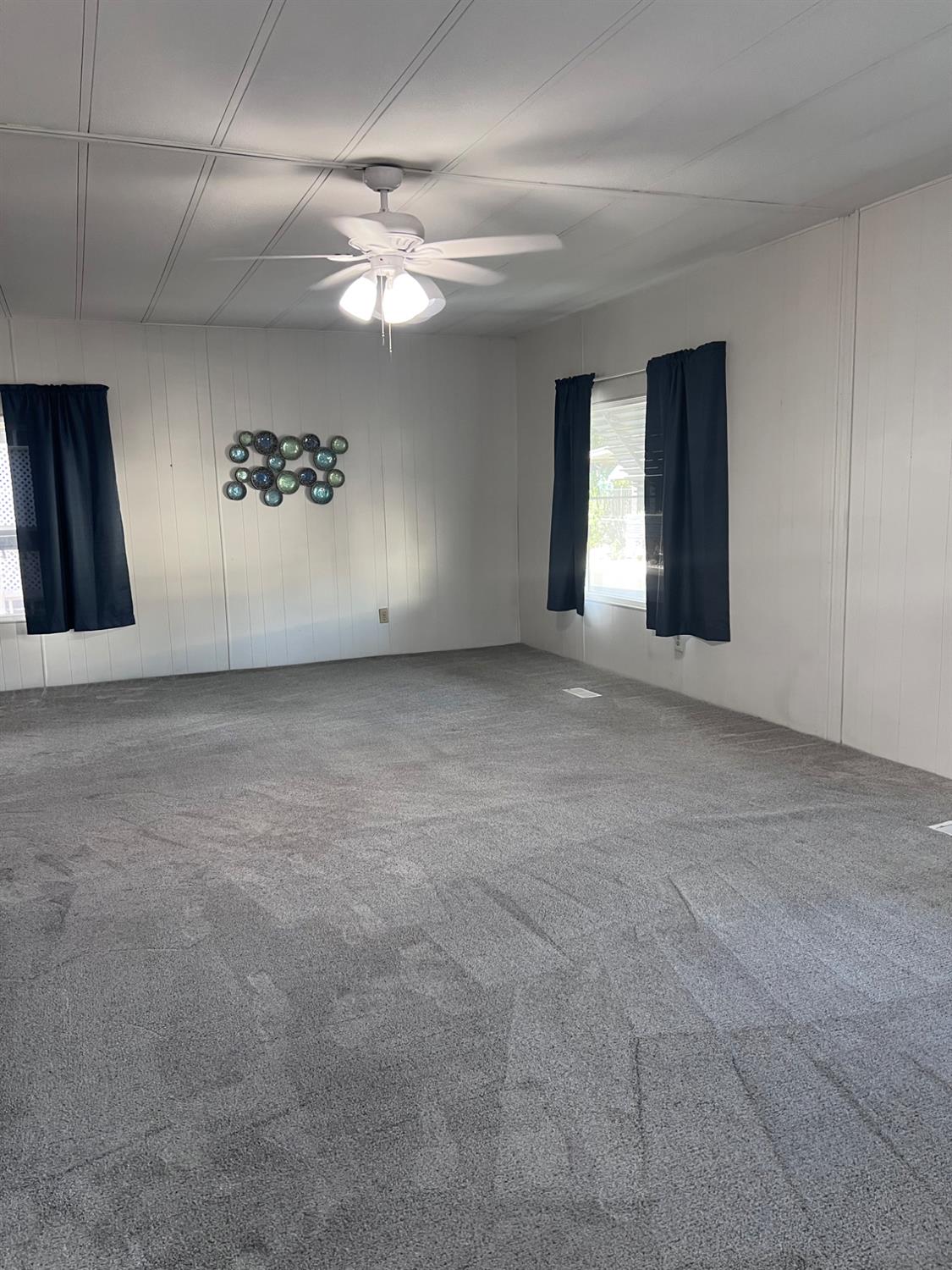 3913 Waimea Lane Modesto, CA 95355 - Photo 8 of 32 a view of a livingroom with a chandelier fan and windows
