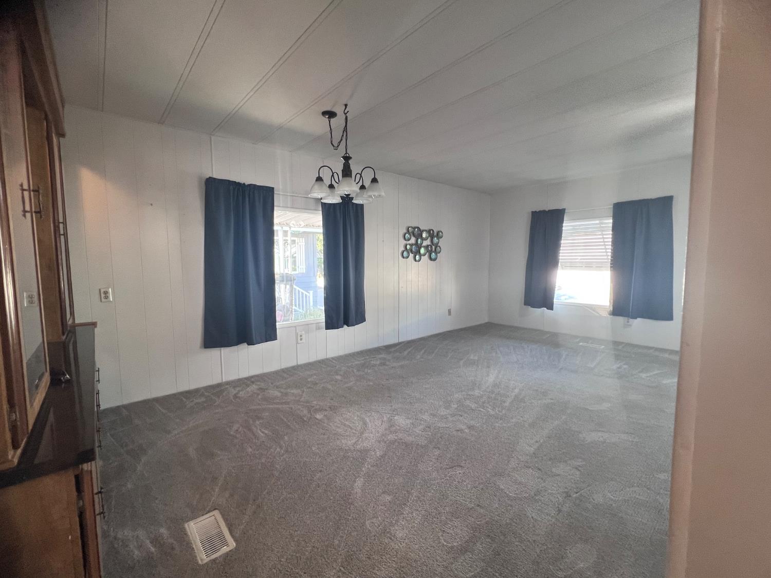 3913 Waimea Lane Modesto, CA 95355 - Photo 10 of 32 a view of an empty room with chandelier and glass door