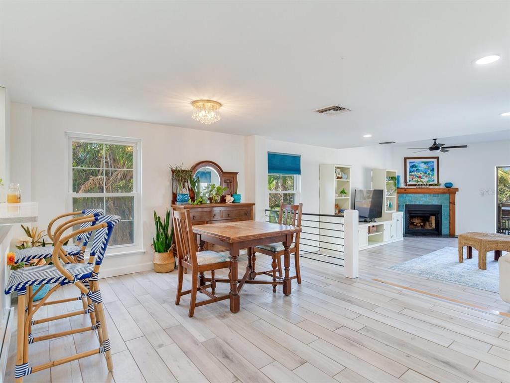 410 140th Avenue East Madeira Beach, FL 33708 - Photo 12 of 77 a dining room with furniture a rug and wooden floor