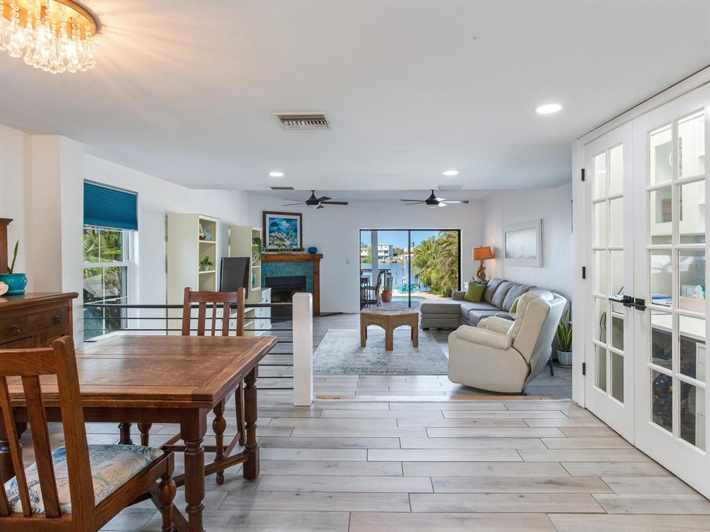 410 140th Avenue East Madeira Beach, FL 33708 - Photo 14 of 77 a living room with furniture a table and chairs