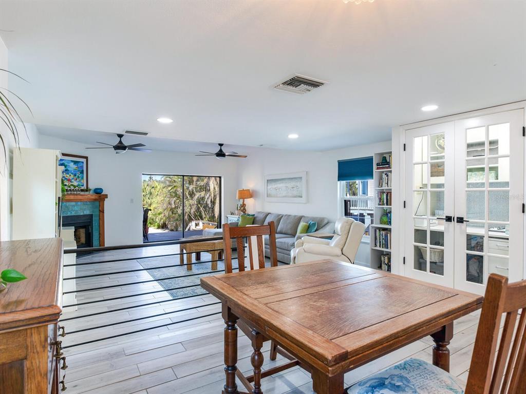 410 140th Avenue East Madeira Beach, FL 33708 - Photo 15 of 77 a view of a dining room with furniture window and wooden floor