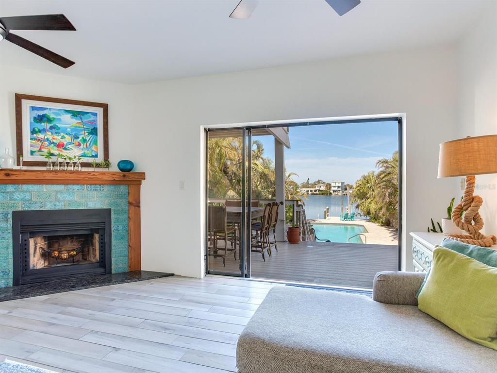 410 140th Avenue East Madeira Beach, FL 33708 - Photo 19 of 77 a living room with furniture and a fireplace