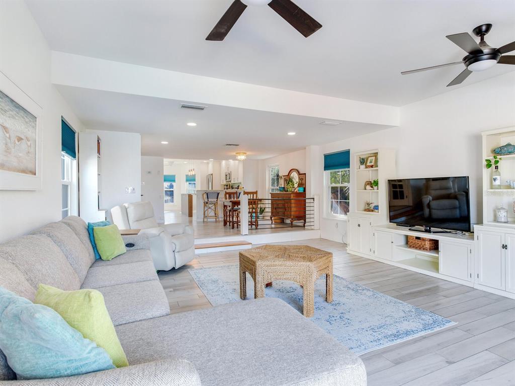 410 140th Avenue East Madeira Beach, FL 33708 - Photo 20 of 77 a living room with furniture and a flat screen tv