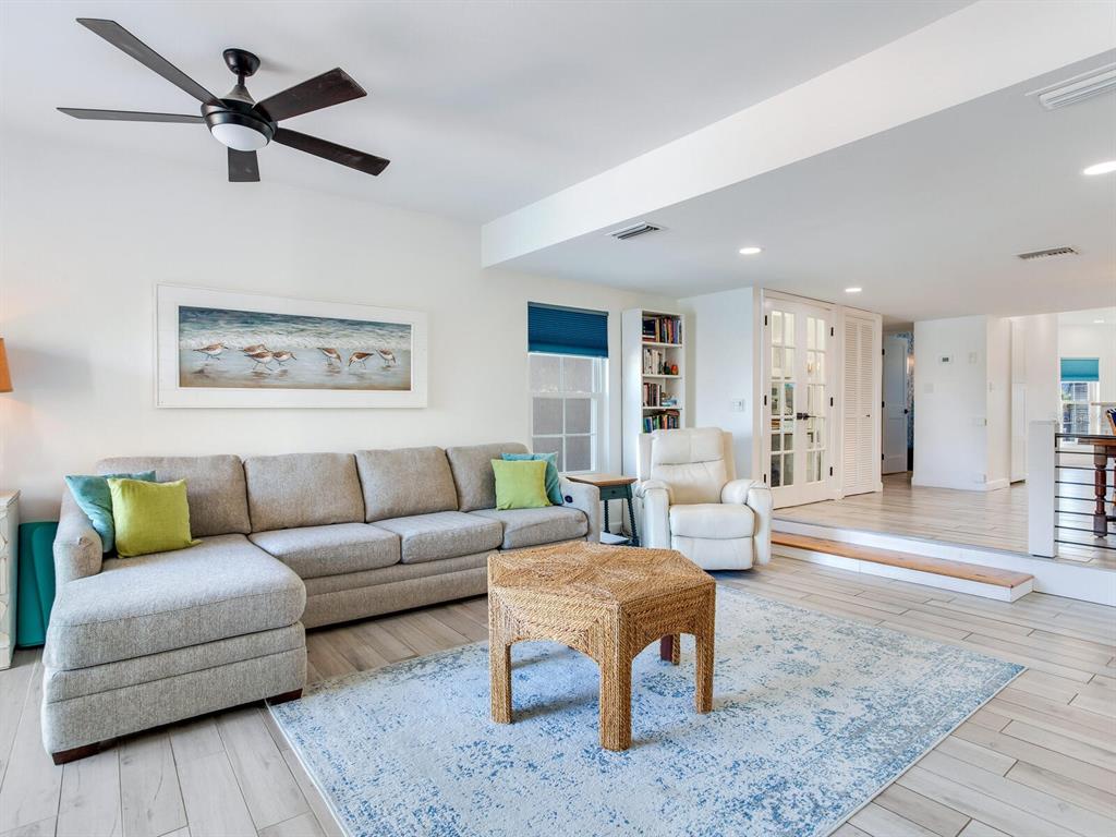 410 140th Avenue East Madeira Beach, FL 33708 - Photo 21 of 77 a living room with furniture and a rug