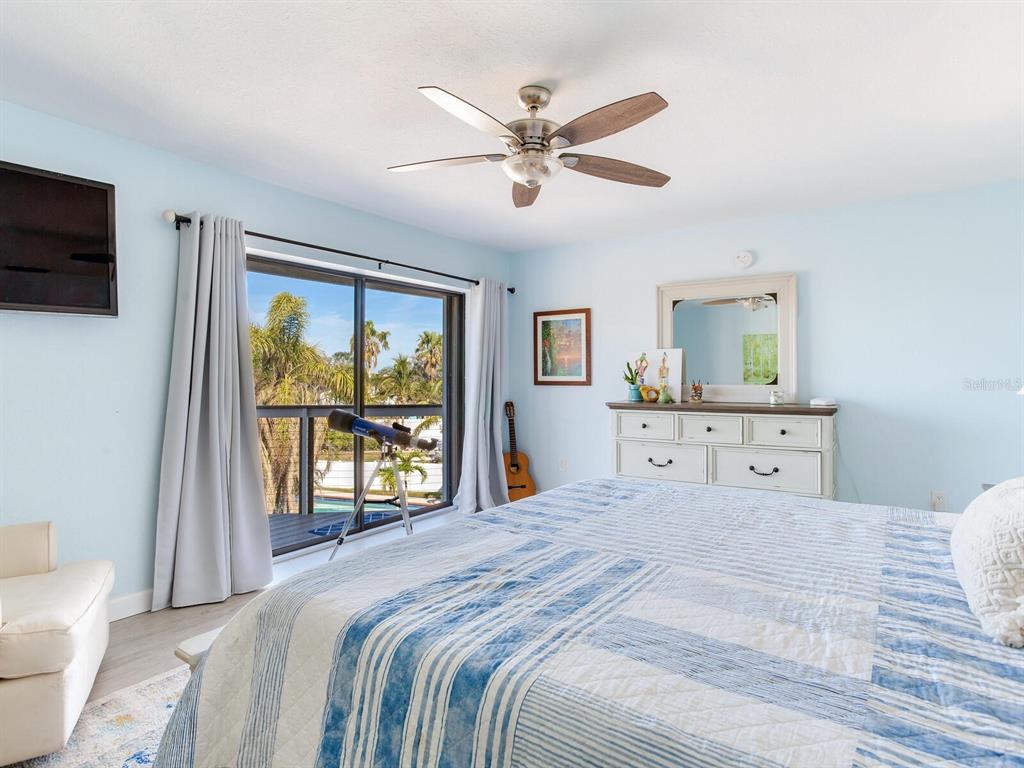 410 140th Avenue East Madeira Beach, FL 33708 - Photo 33 of 77 a bedroom with a large bed and a window