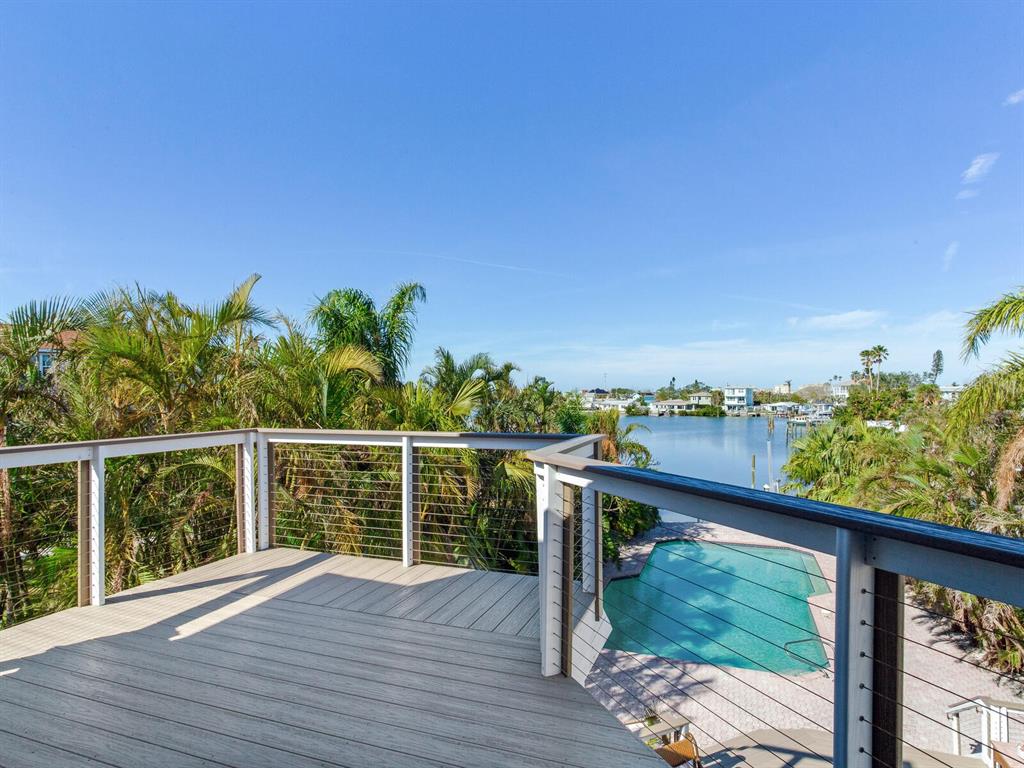 410 140th Avenue East Madeira Beach, FL 33708 - Photo 35 of 77 a view of a balcony with wooden floor and fence