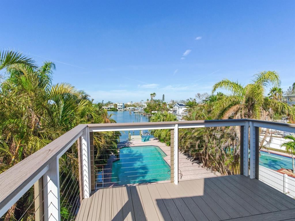410 140th Avenue East Madeira Beach, FL 33708 - Photo 36 of 77 a view of a balcony with wooden floor and fence