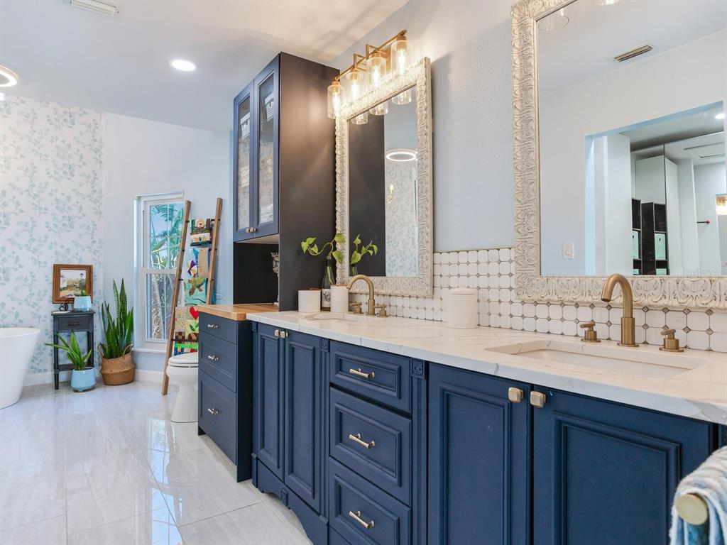 410 140th Avenue East Madeira Beach, FL 33708 - Photo 40 of 77 a bathroom with a sink double vanity and a mirror