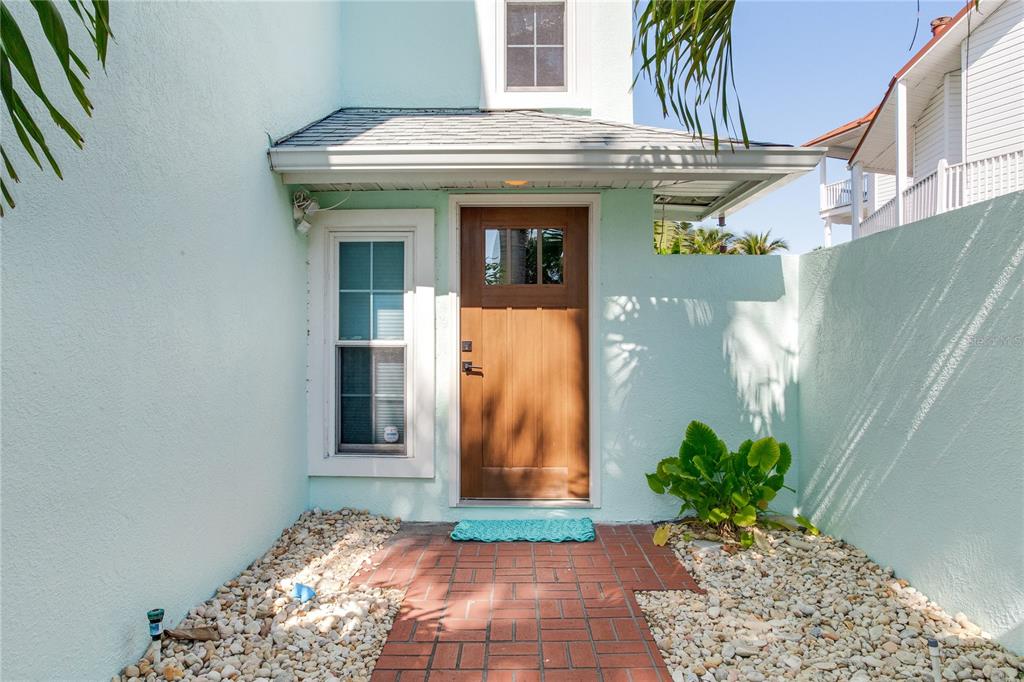 410 140th Avenue East Madeira Beach, FL 33708 - Photo 4 of 77 a view of a entryway door of the house