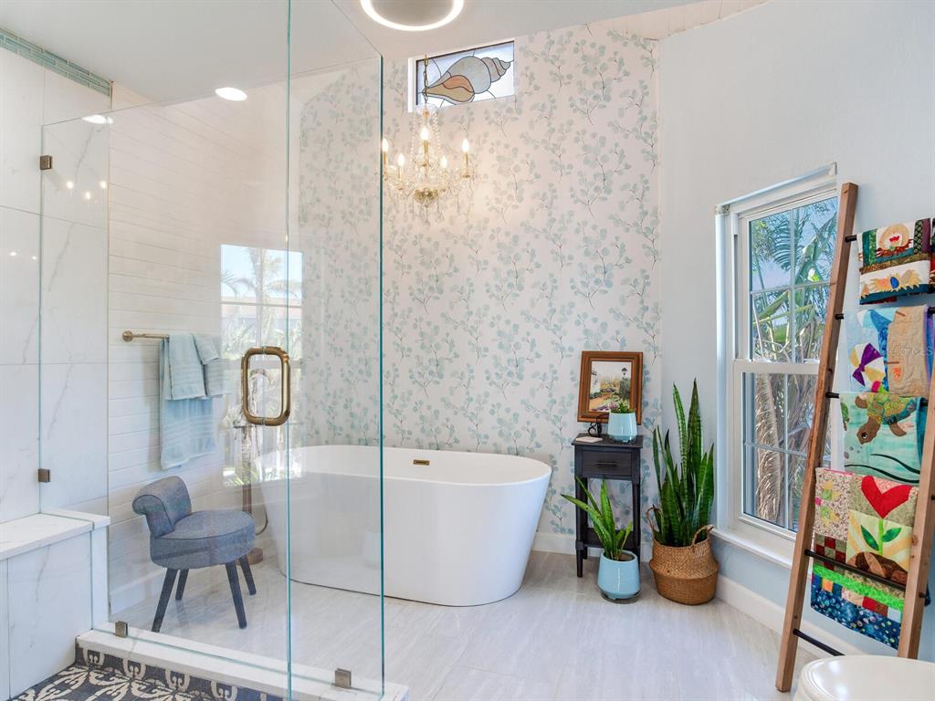 410 140th Avenue East Madeira Beach, FL 33708 - Photo 41 of 77 a bathroom with a tub shower and a sink