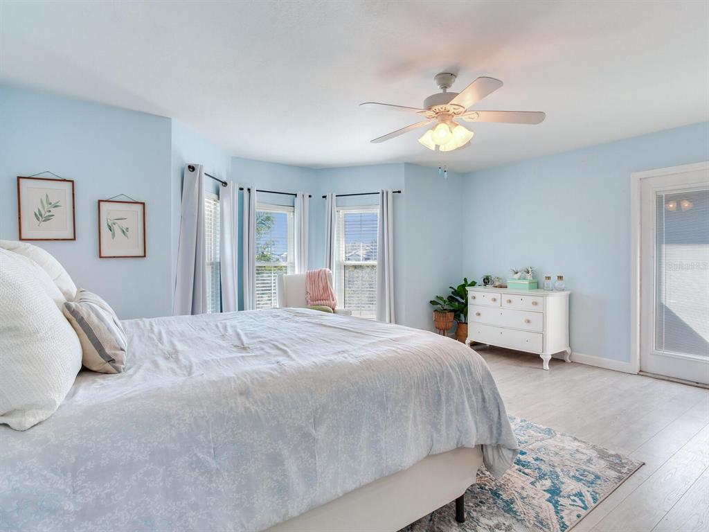 410 140th Avenue East Madeira Beach, FL 33708 - Photo 46 of 77 a bedroom with a bed and a chandelier