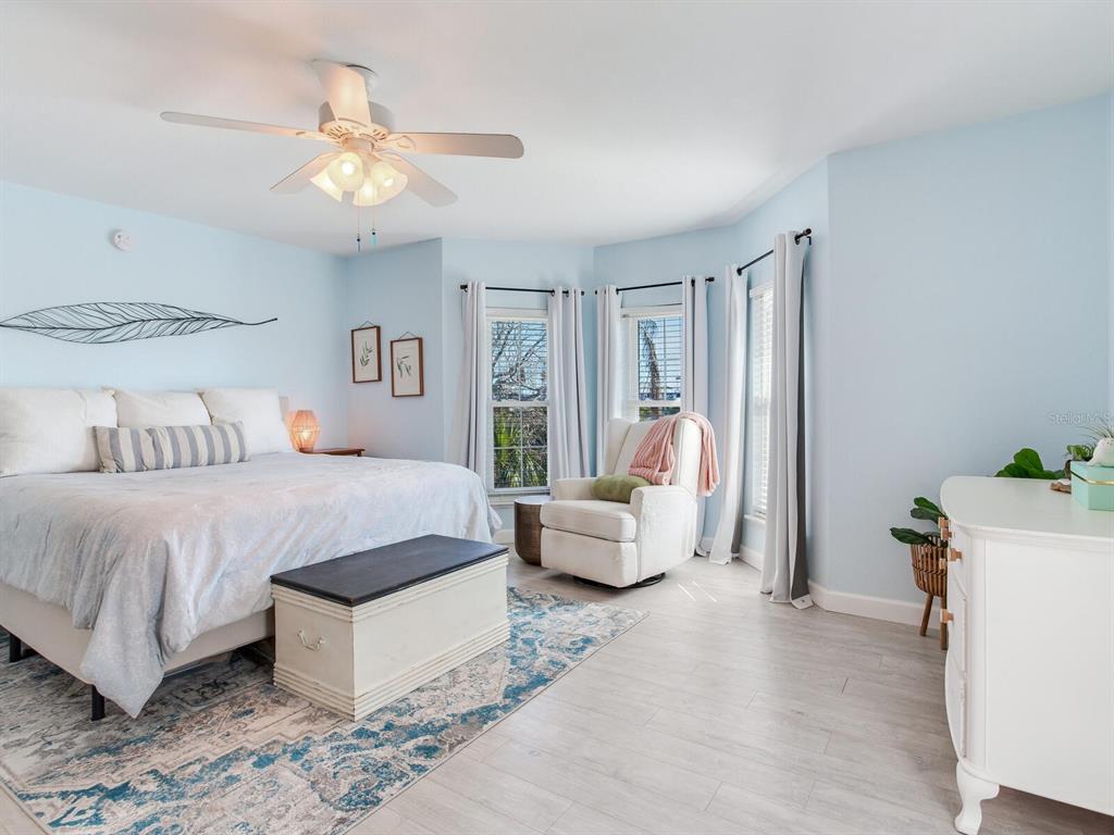 410 140th Avenue East Madeira Beach, FL 33708 - Photo 47 of 77 a spacious bedroom with a bed and a chandelier