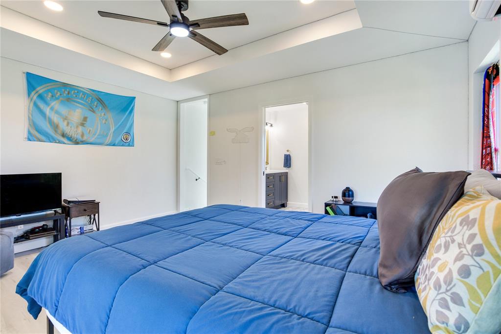 410 140th Avenue East Madeira Beach, FL 33708 - Photo 58 of 77 a bed room with a bed and a television