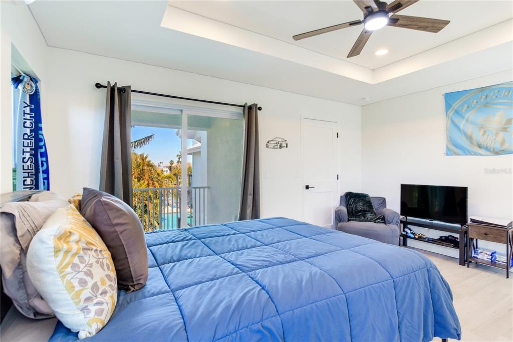 410 140th Avenue East Madeira Beach, FL 33708 - Photo 59 of 77 a bedroom with a bed and a chandelier