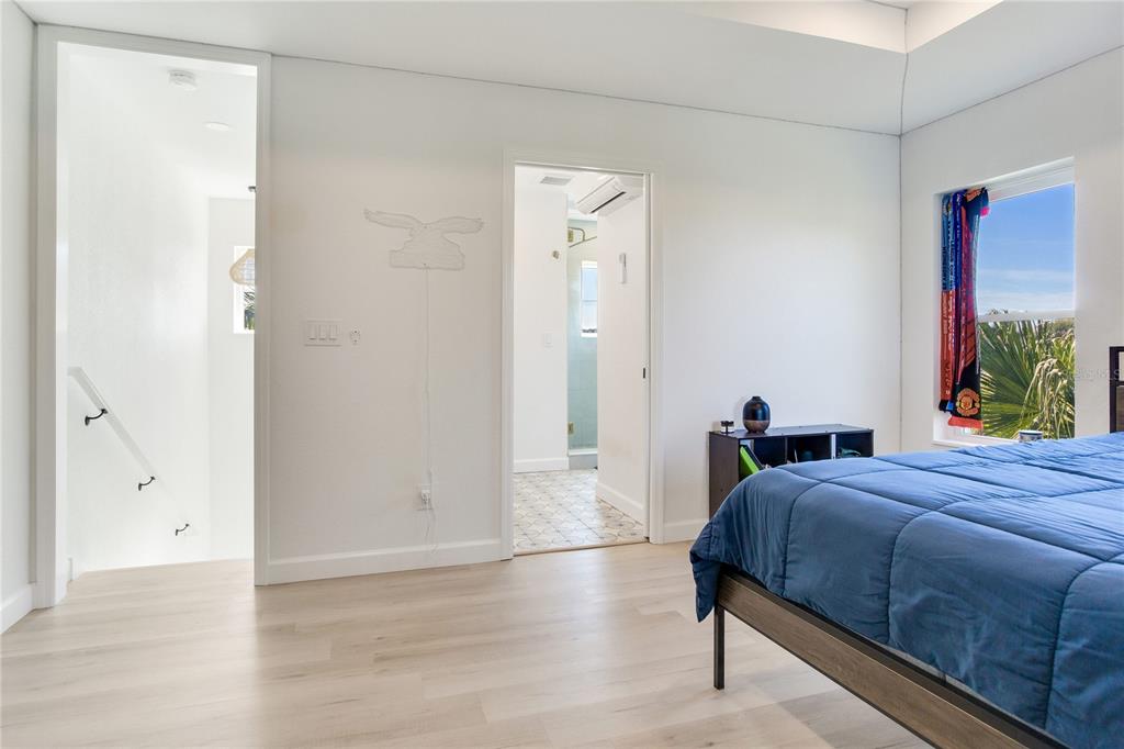 410 140th Avenue East Madeira Beach, FL 33708 - Photo 60 of 77 a bedroom with a bed and a window