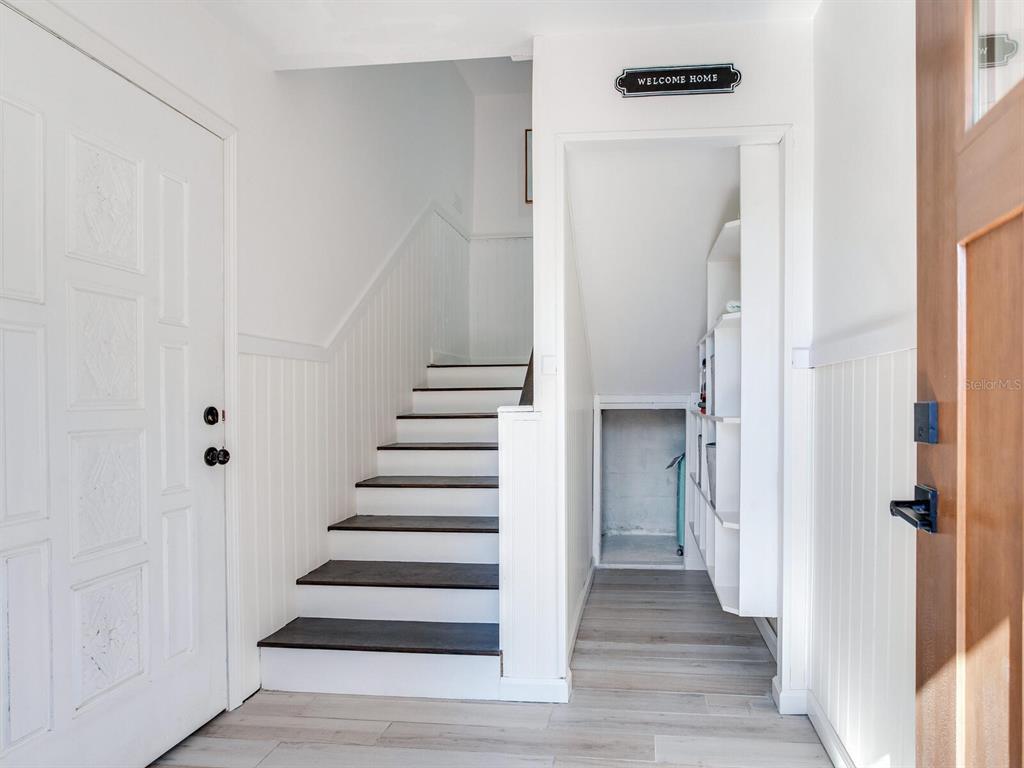410 140th Avenue East Madeira Beach, FL 33708 - Photo 9 of 77 a view of a hallway with wooden floor and entryway