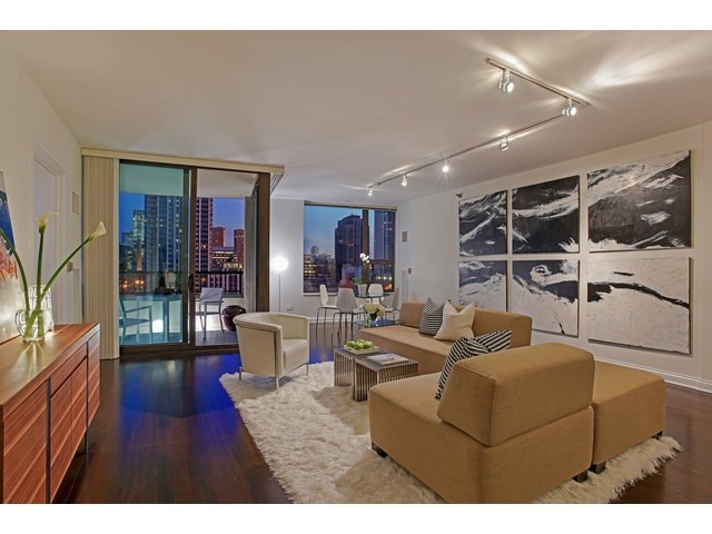 501 North Clinton Street, Unit 904 Chicago, IL 60654 - Photo 3 of 25 a living room with furniture a large window and wooden floor