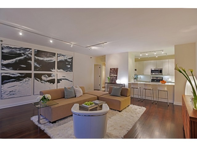 501 North Clinton Street, Unit 904 Chicago, IL 60654 - Photo 8 of 25 a living room with furniture and a wooden floor