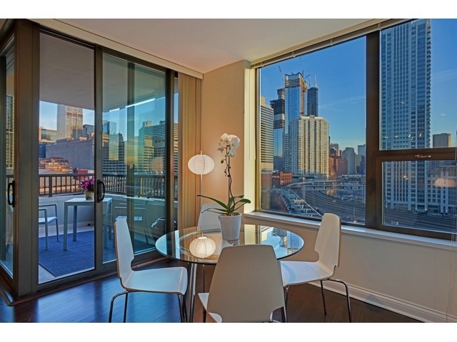 501 North Clinton Street, Unit 904 Chicago, IL 60654 - Photo 9 of 25 a view of a dining room with furniture window and wooden floor