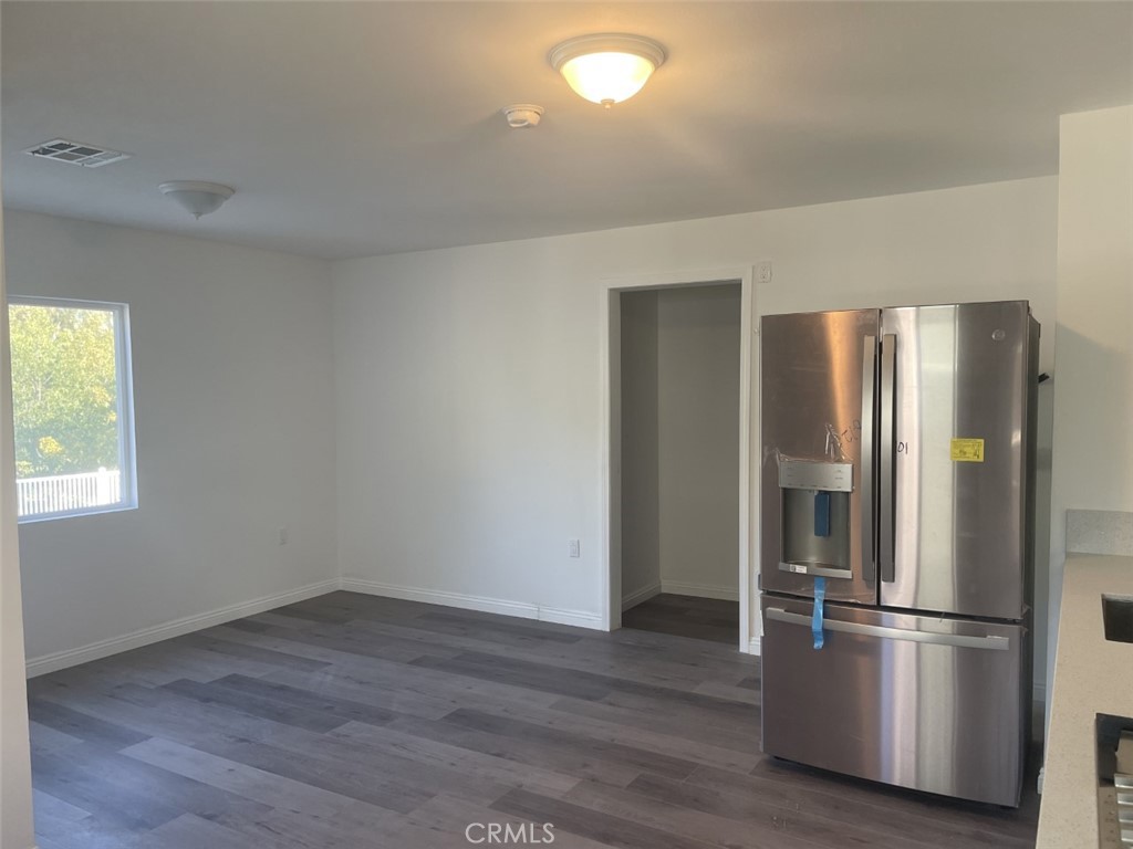 145 Miramonte Drive Fullerton, CA 92835 - Photo 5 of 8 a kitchen with a refrigerator and wooden floor