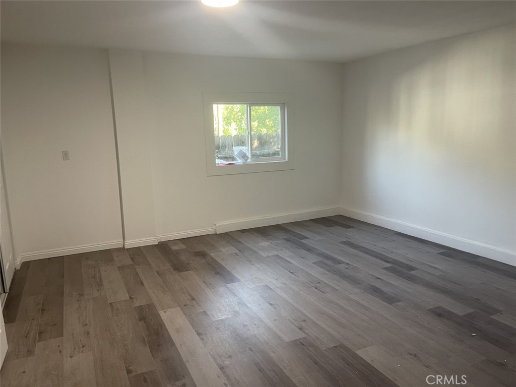 145 Miramonte Drive Fullerton, CA 92835 - Photo 7 of 8 a view of an empty room with wooden floor and a window