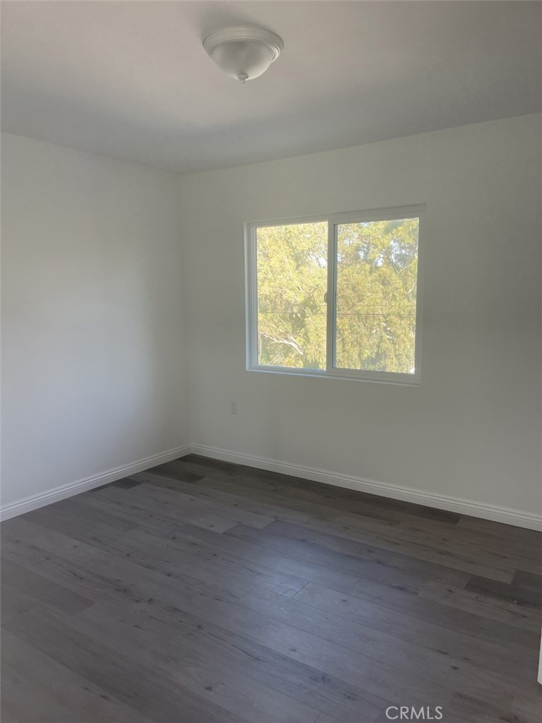 145 Miramonte Drive Fullerton, CA 92835 - Photo 8 of 8 an empty room with wooden floor and windows