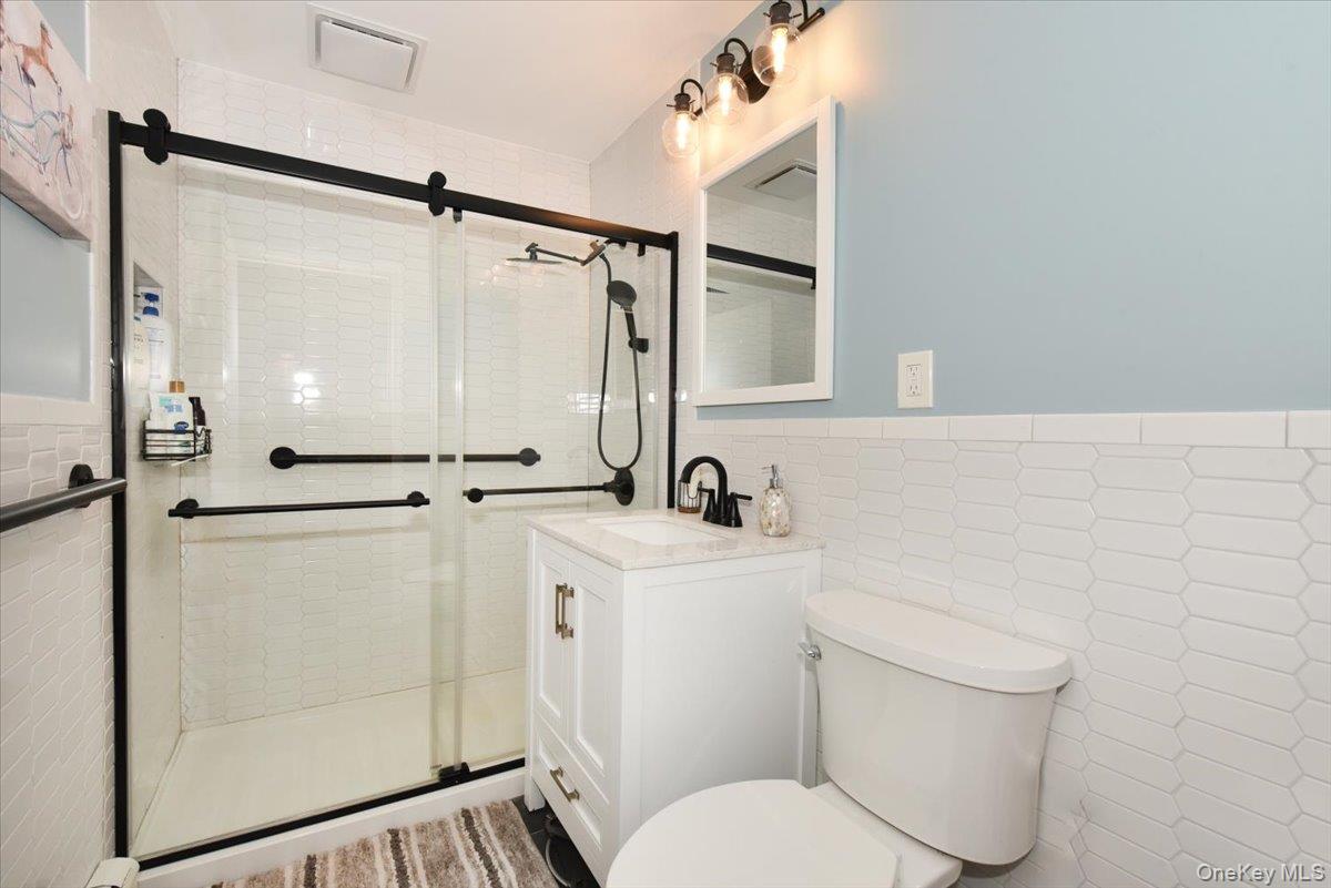 307 Blacksmith Road Levittown, NY 11756 - Photo 18 of 27 a bathroom with a sink toilet and shower