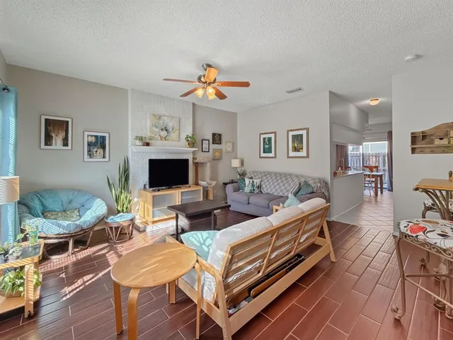 a living room with furniture a fireplace and a flat screen tv