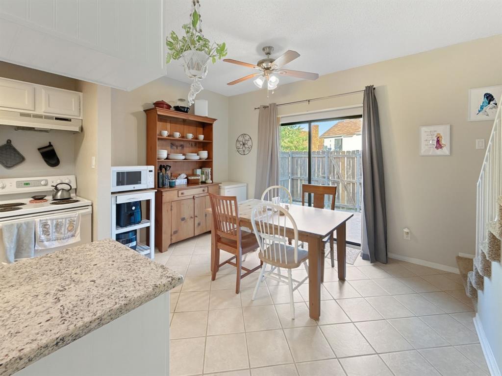214 Samuel Boulevard, Unit 1H Coppell, TX 75019 - Photo 16 of 21 a view of kitchen with sink refrigerator dining table and chairs